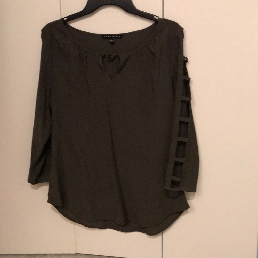 A green blouse with cut outs on the arms